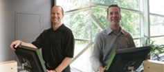 Dr Yurij Chewpa and Dr Ed Quirk from Warrior Coaching using the NexySoft Software at their chiropractic clinic.